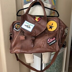 Trisha’s Travel Bag w/ her destination patches